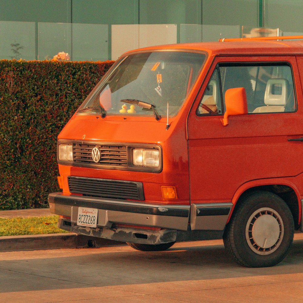 a red van parked on the side of a road