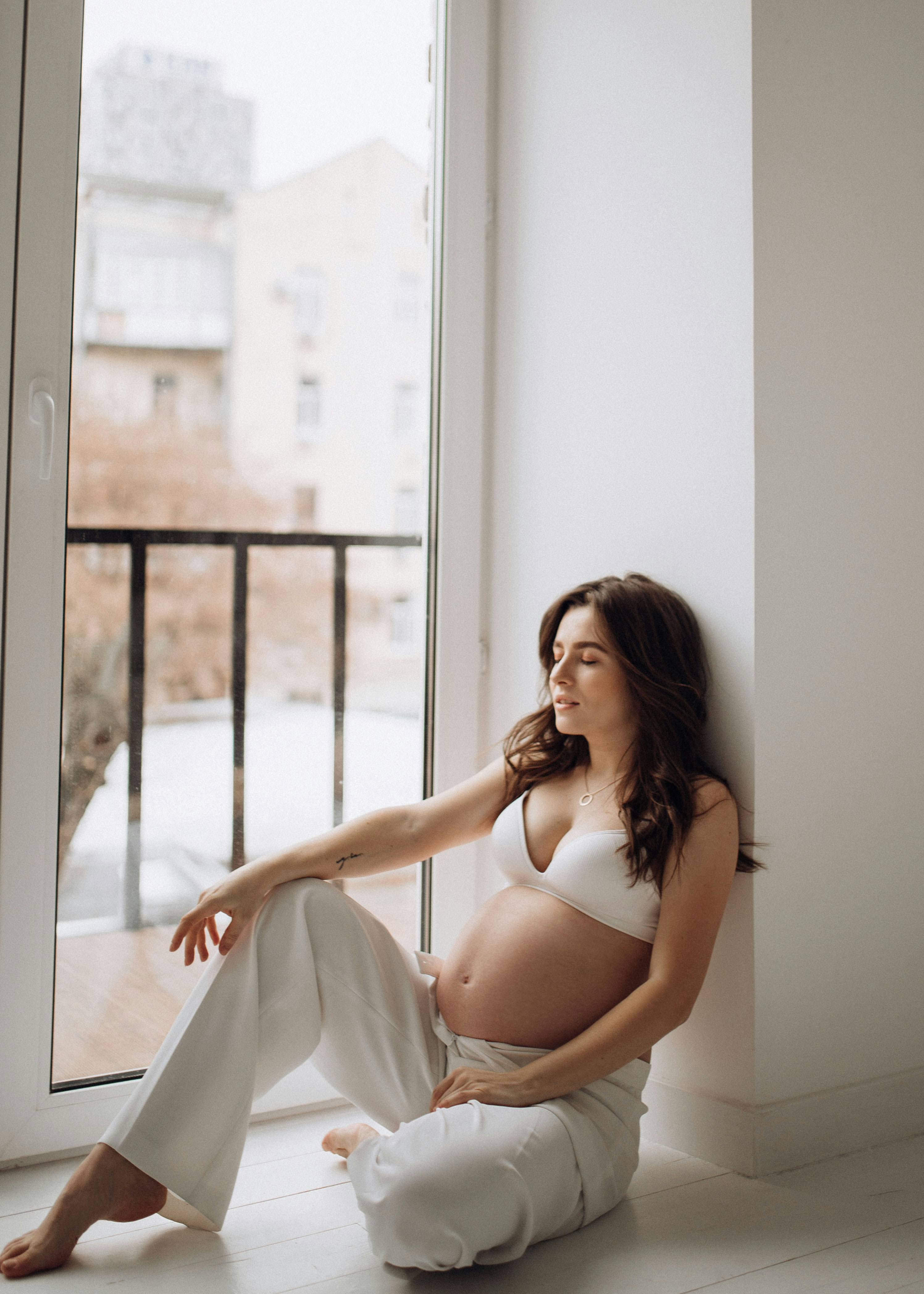 a woman sitting on a window sill