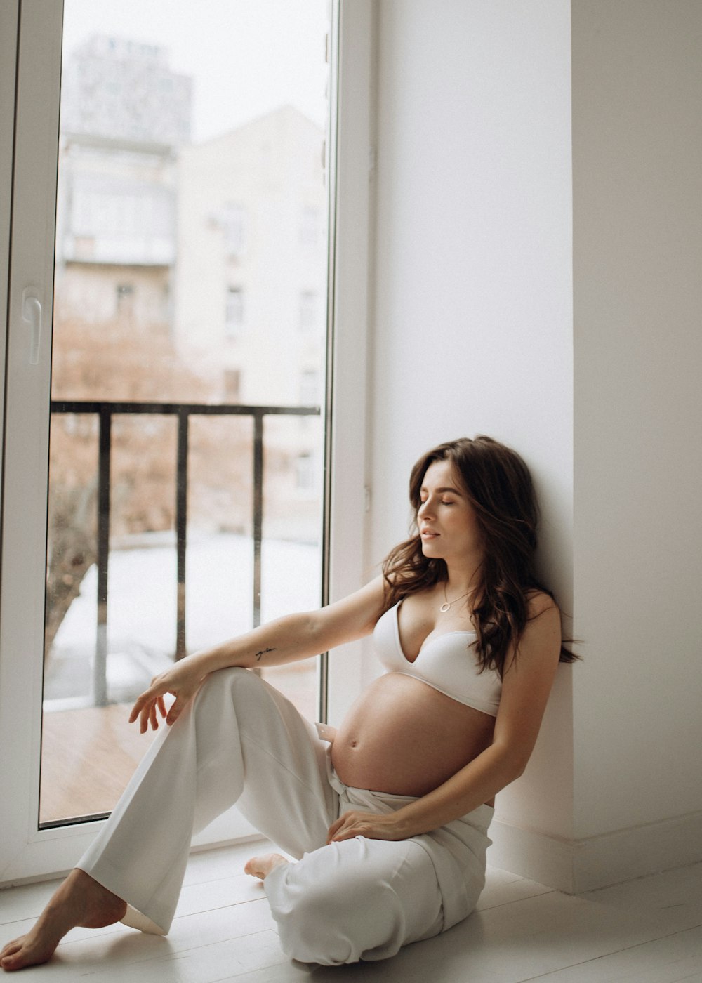 a woman sitting on a window sill