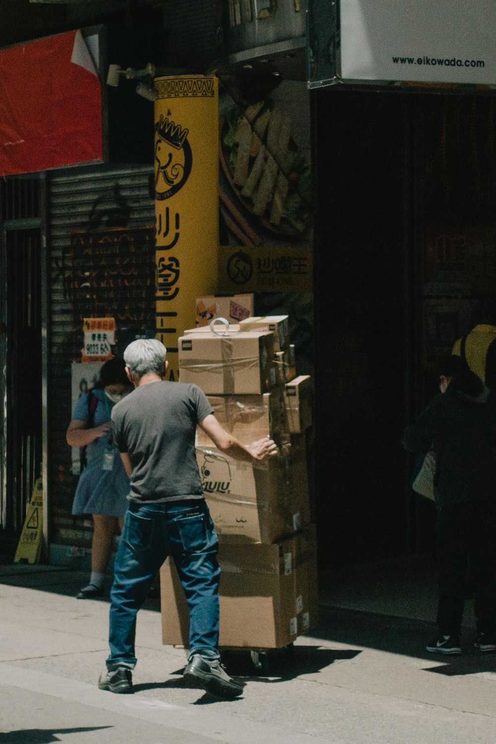 a man standing next to a stack of boxes