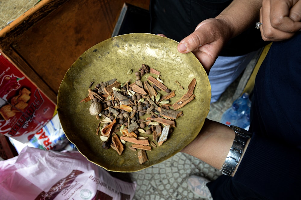 a person holding a bowl of food