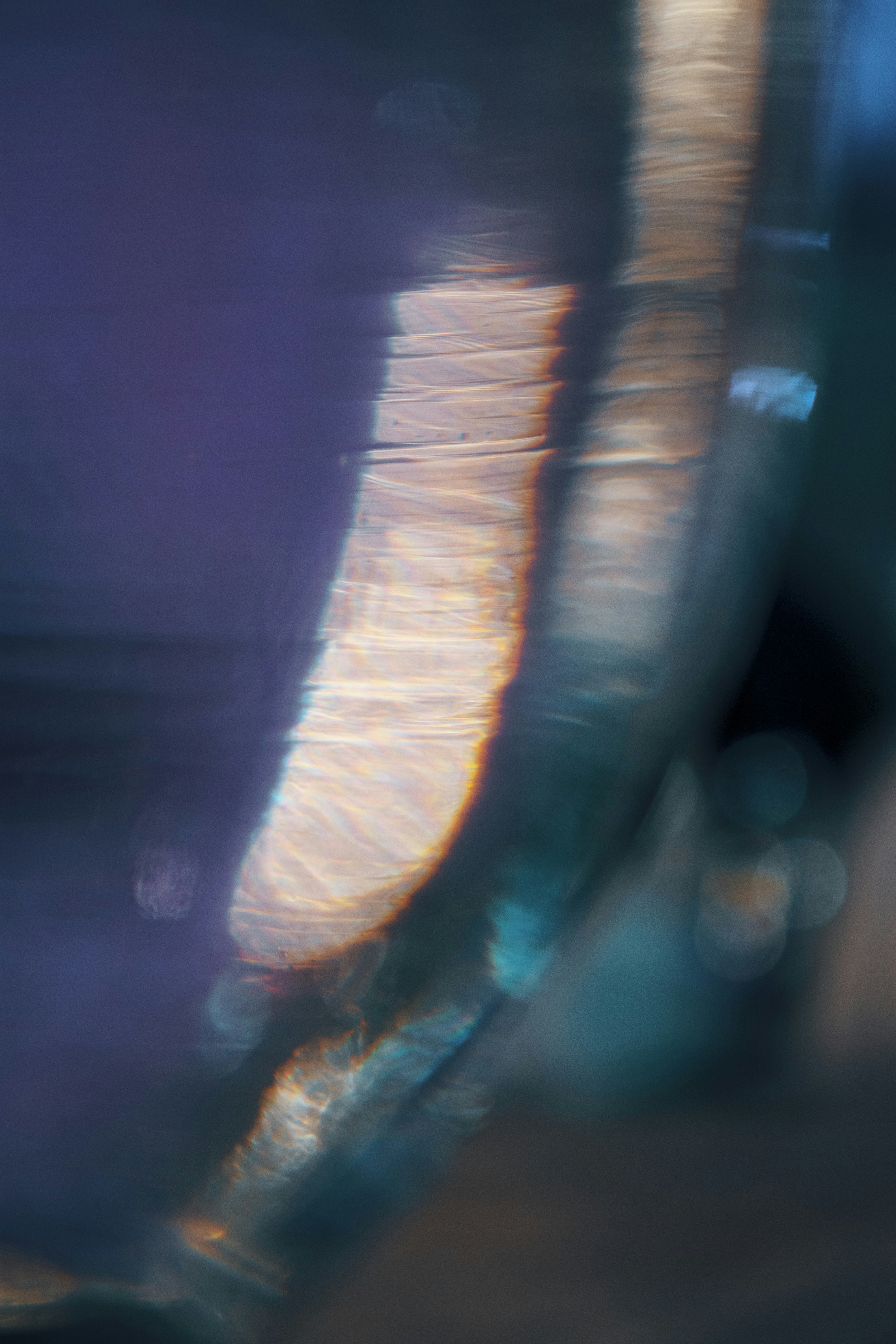 Abstract light rays in deep violet and gold tones forming geometric patterns, sacred and cosmic