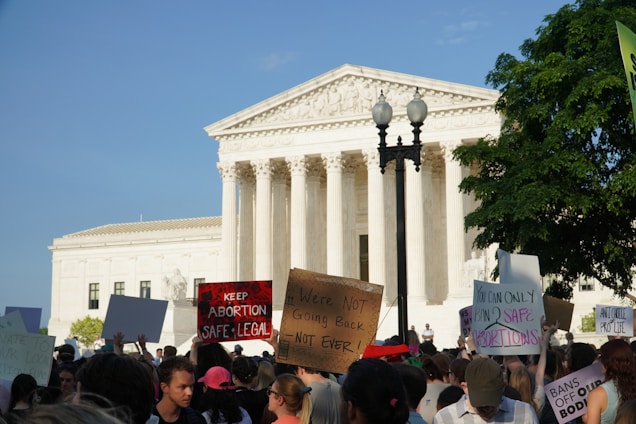 a crowd of people outside of a white building