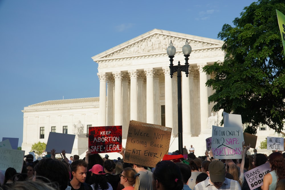 a crowd of people outside of a white building