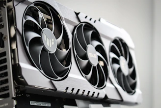 Close-up of a 3D printed fan cover with intricate design and a matte finish, mounted on a gaming PC.