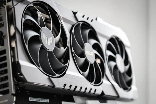 Close-up of a 3D printed fan cover with intricate design and a matte finish, mounted on a gaming PC.