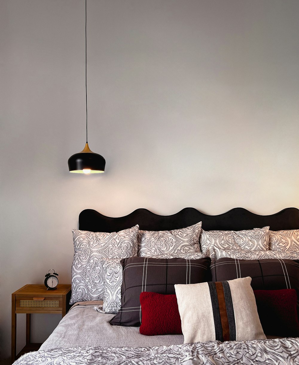 a bed with pillows and a lamp