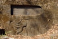 a stone wall with a statue of an elephant on it