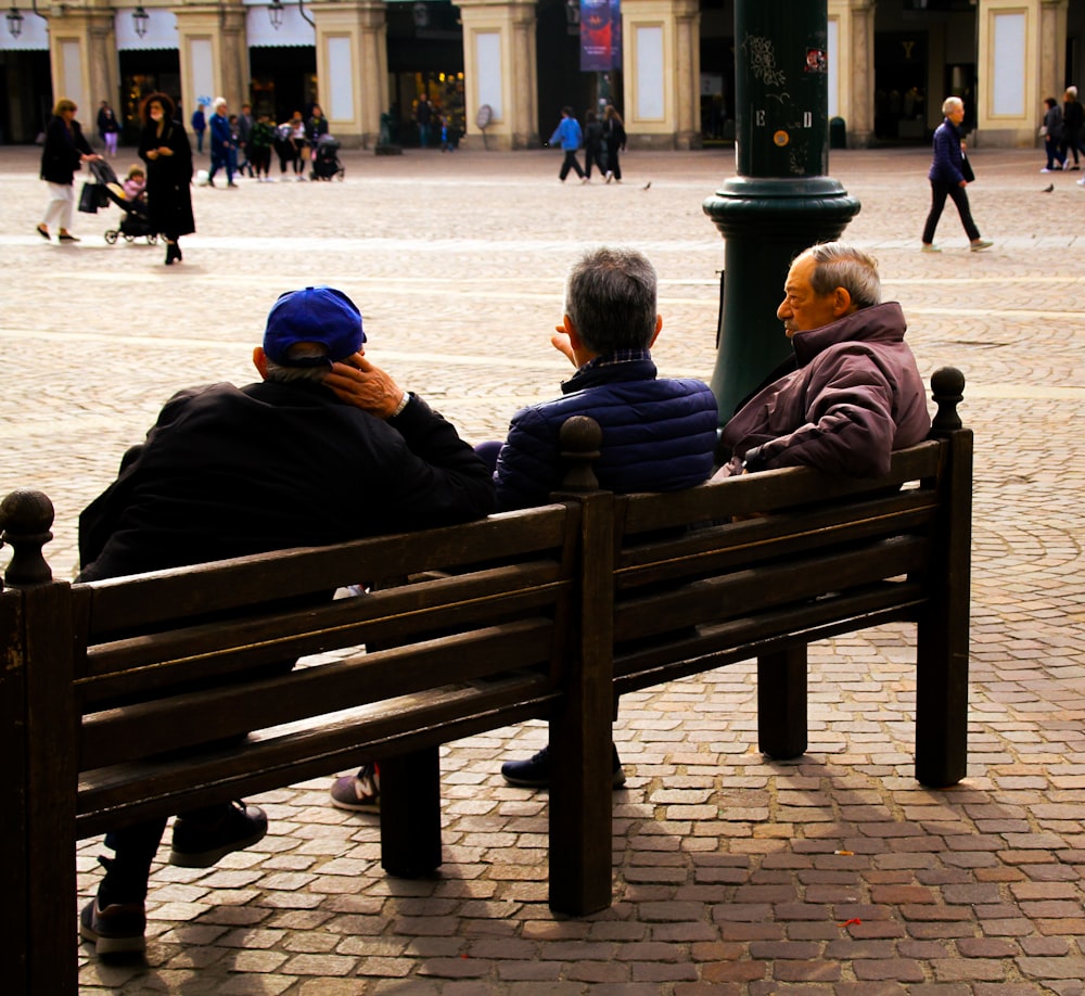 a group of people sit on a bench