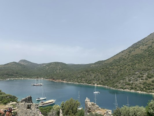 A body of water with boats in it and hills in the back — Fethiye & Ölüdeniz, Turkey
