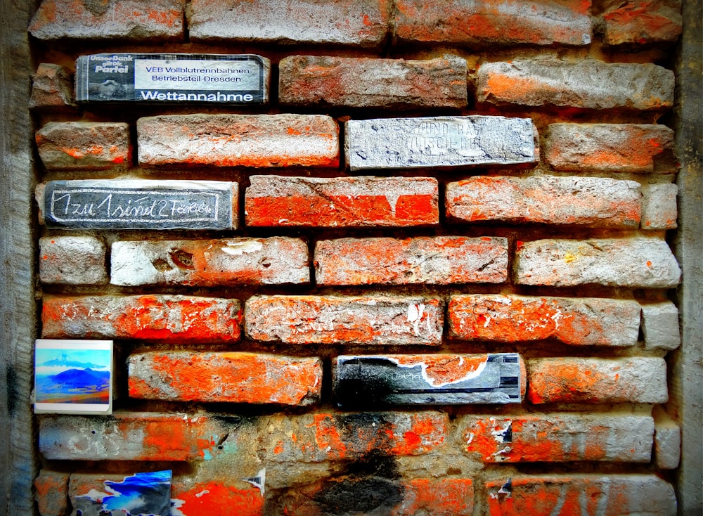 a brick wall with a sign on it