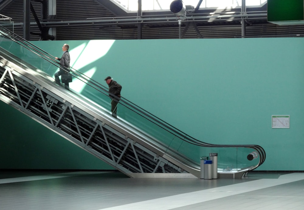 a couple of men standing on a green ramp