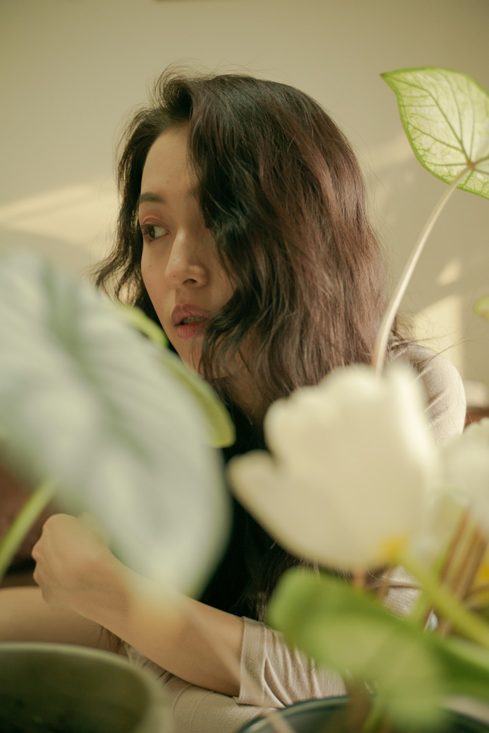 a woman holding a white flower