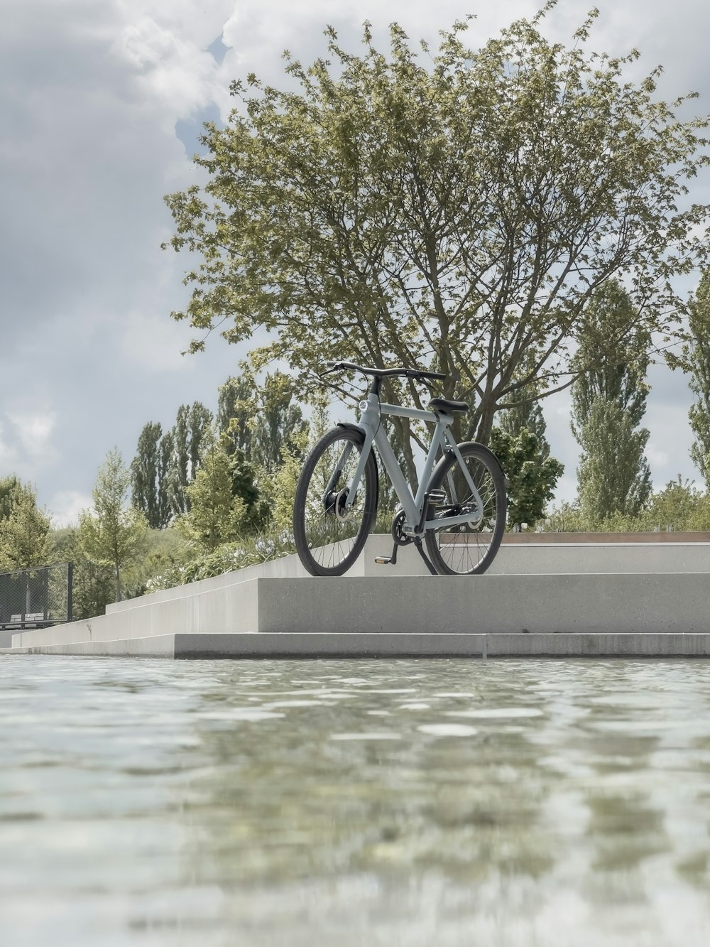 a bicycle leaning against a tree