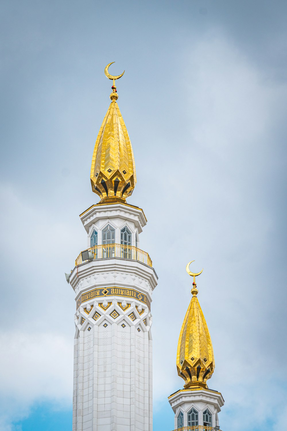 a tall tower with gold domes