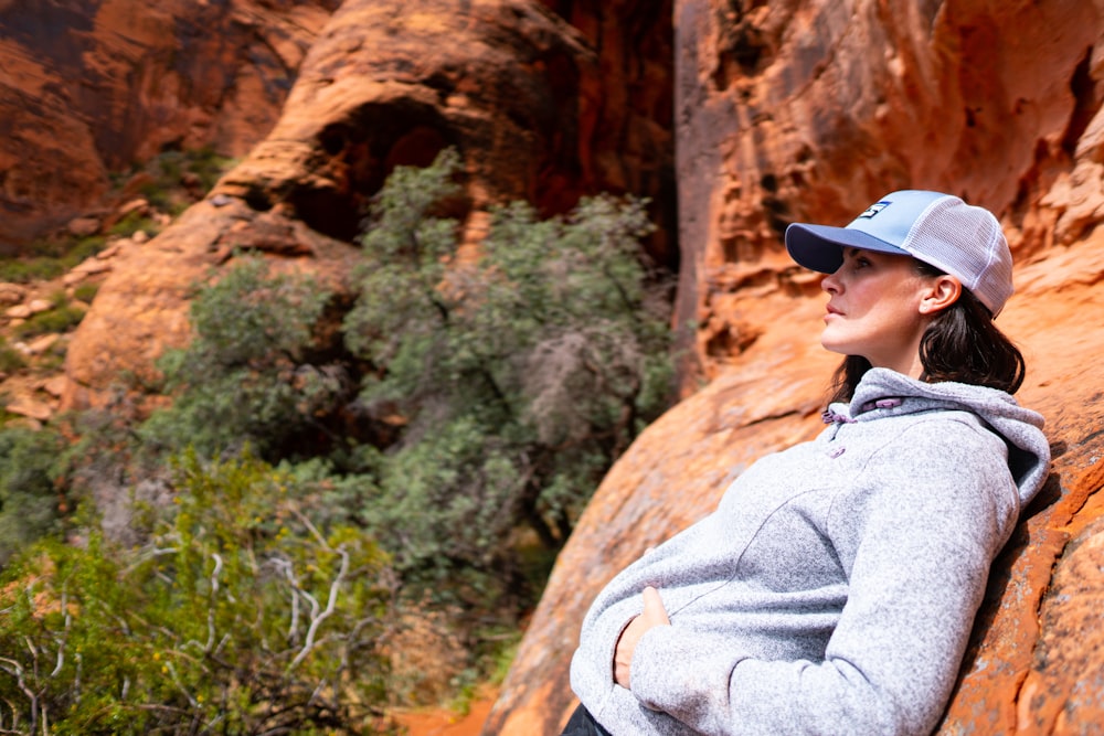 a man standing in front of a rock formation