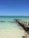 A serene view of the turquoise waters at the Lobos island pier under a clear blue sky.