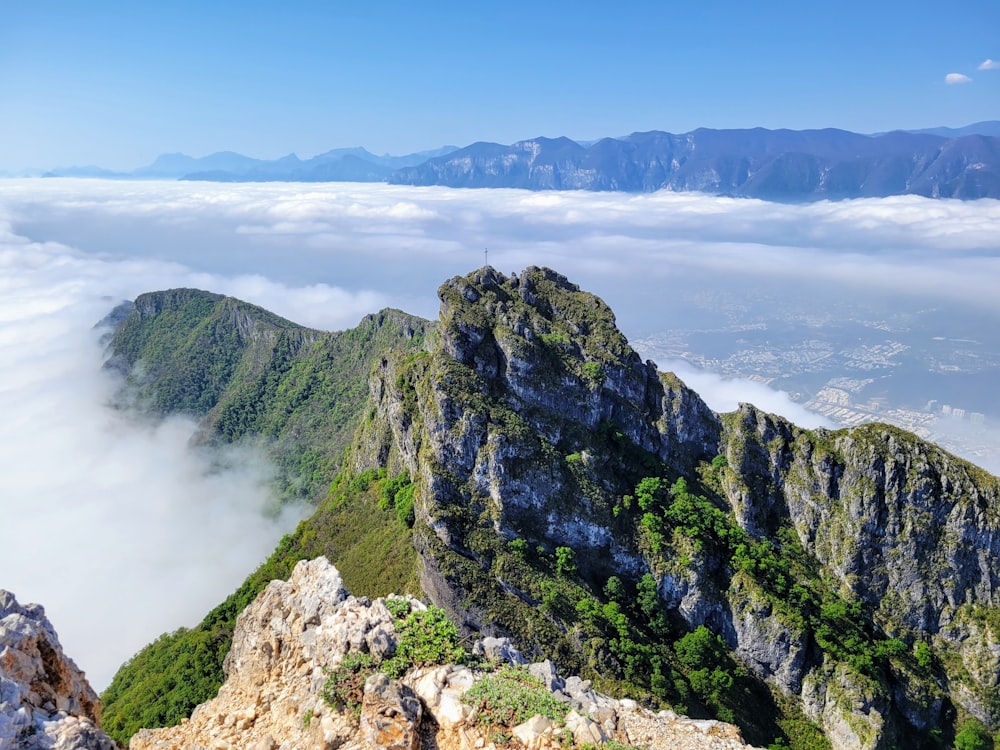 a mountain with clouds below