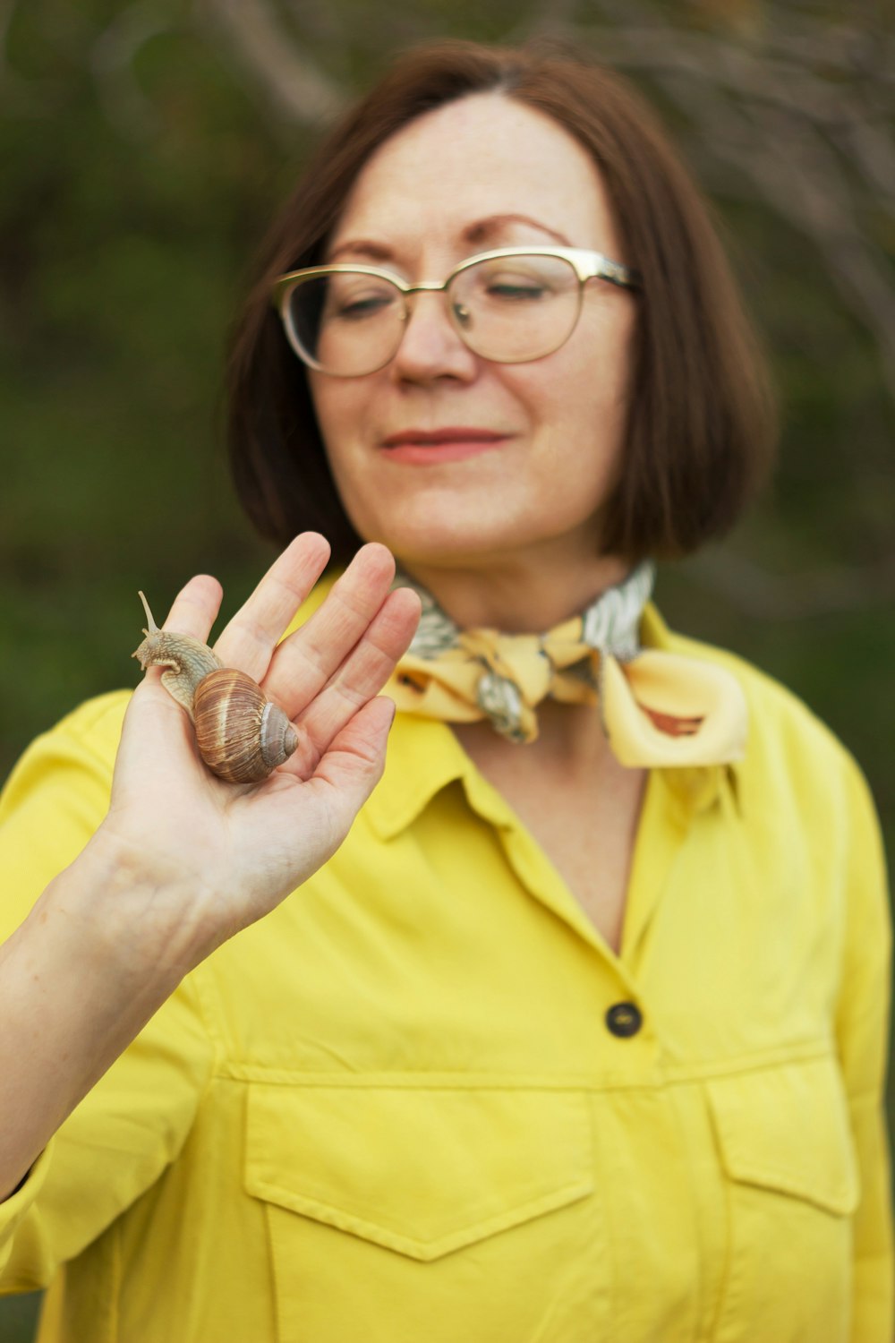 a woman holding a snail