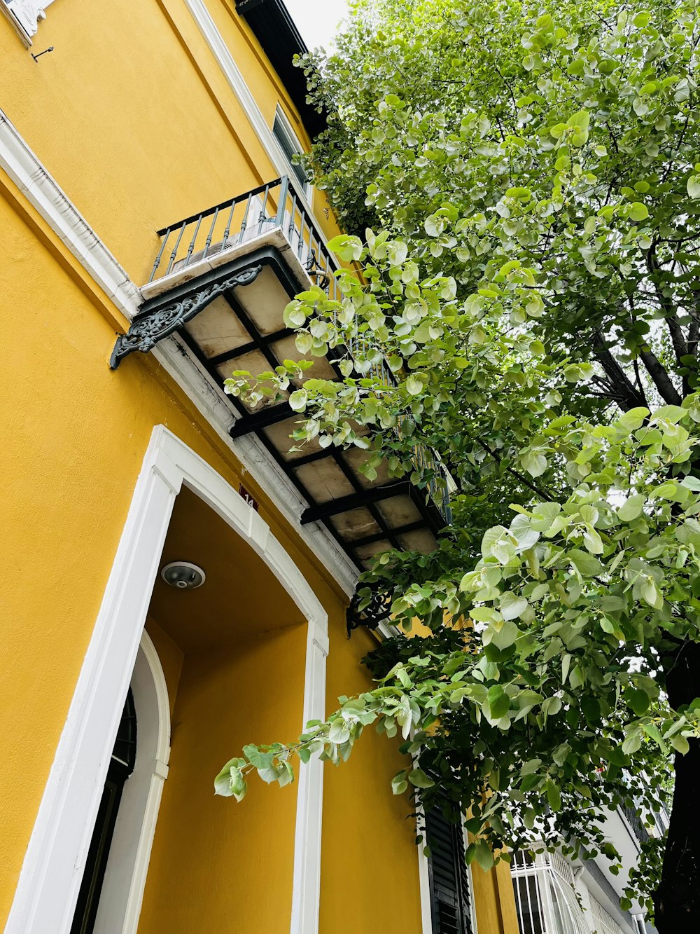 a yellow building with a balcony