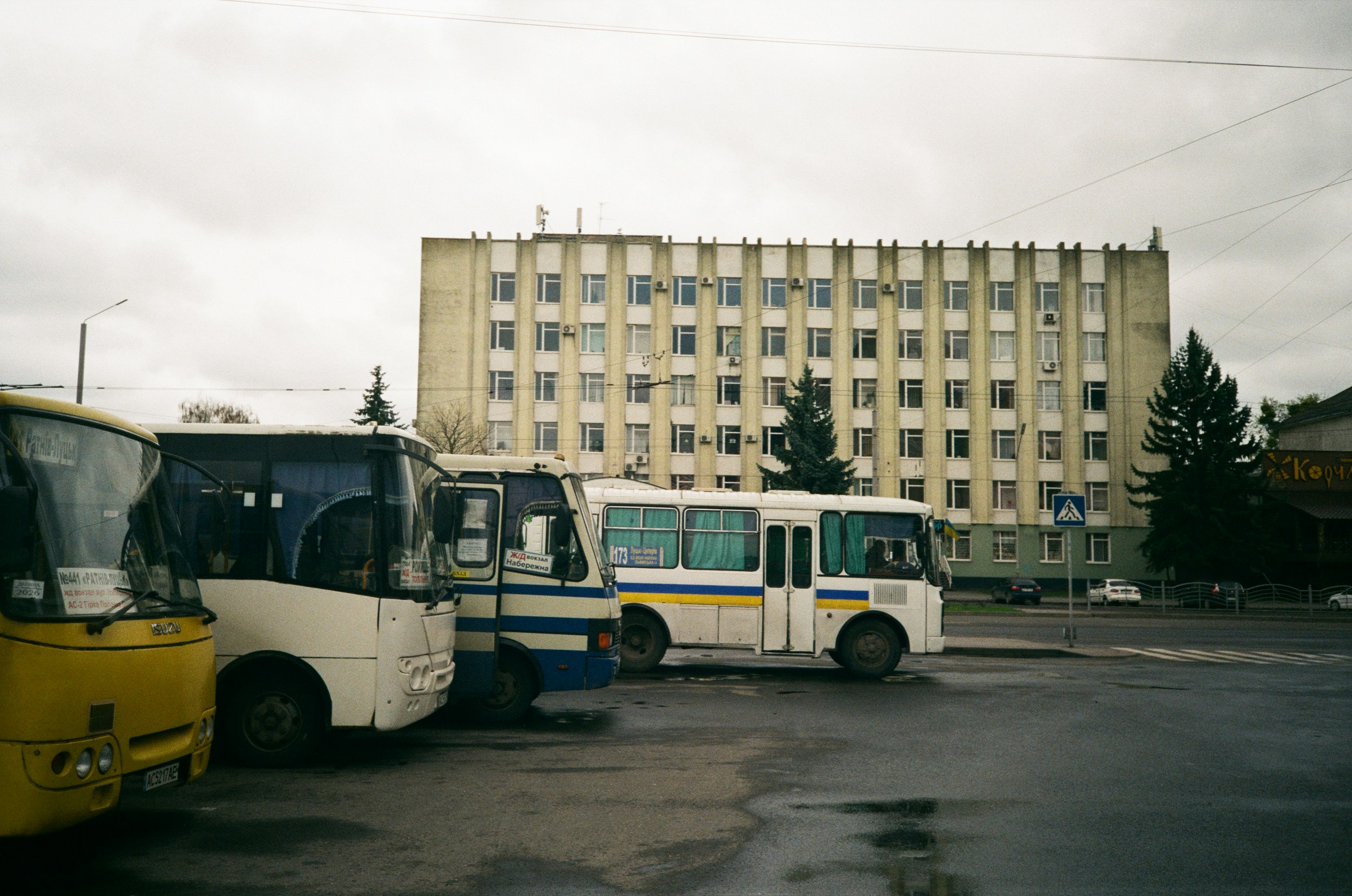 a group of buses parked in front of a building