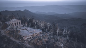 An ancient stone altar surrounded by swirling mist, with ethereal light beams piercing through the fog.