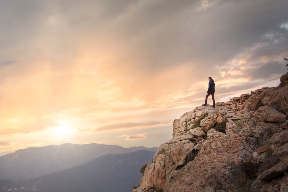 a person standing on a rocky hill