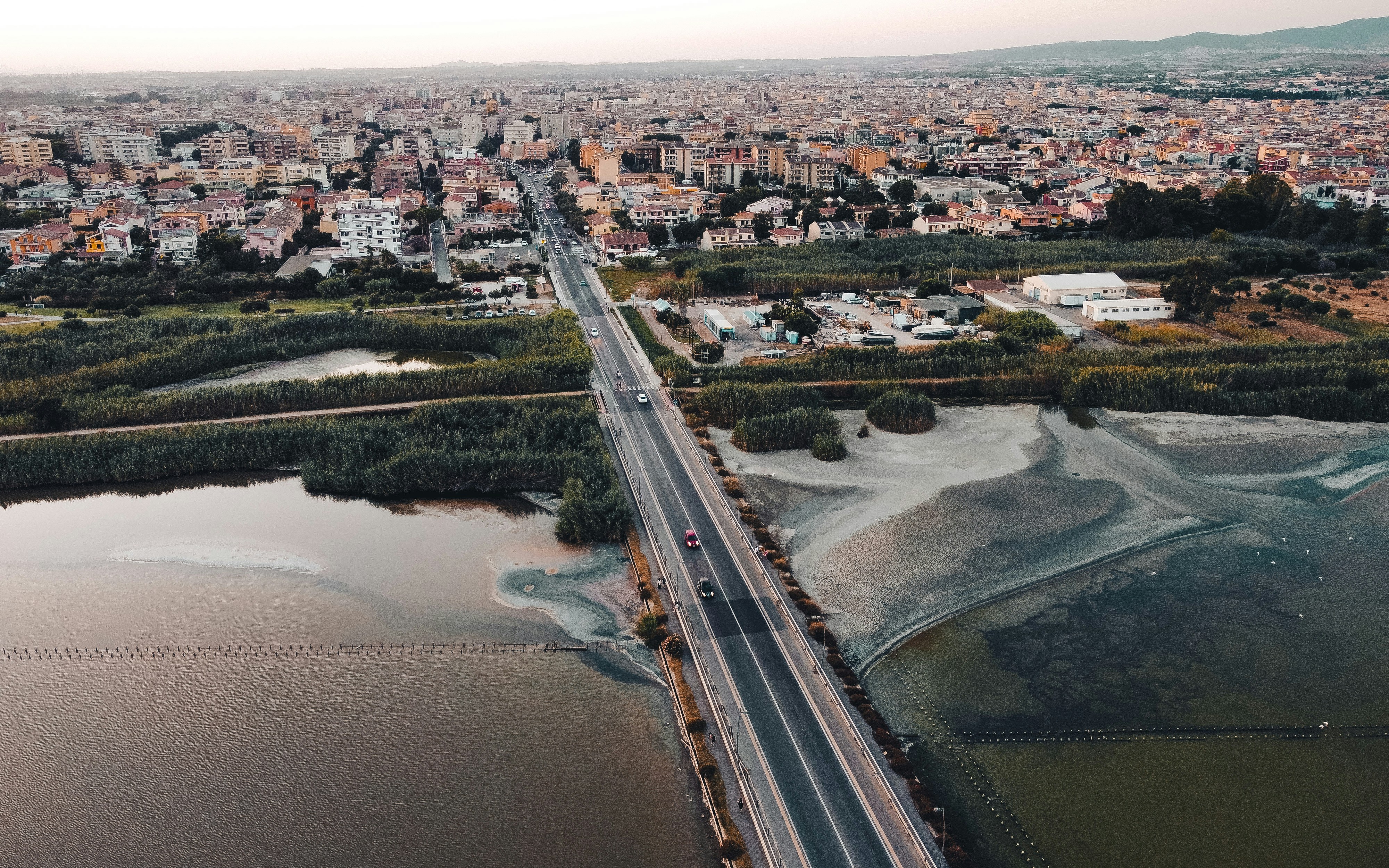 a river with a bridge and buildings