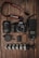 A collection of photography equipment is neatly arranged on a wooden surface. Items include a Canon DSLR camera with a lens attached, an additional lens, a camera strap, memory cards, battery, a flexible tripod, a camera flash unit, and a lens cap.