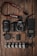 A collection of photography equipment is neatly arranged on a wooden surface. Items include a Canon DSLR camera with a lens attached, an additional lens, a camera strap, memory cards, battery, a flexible tripod, a camera flash unit, and a lens cap.