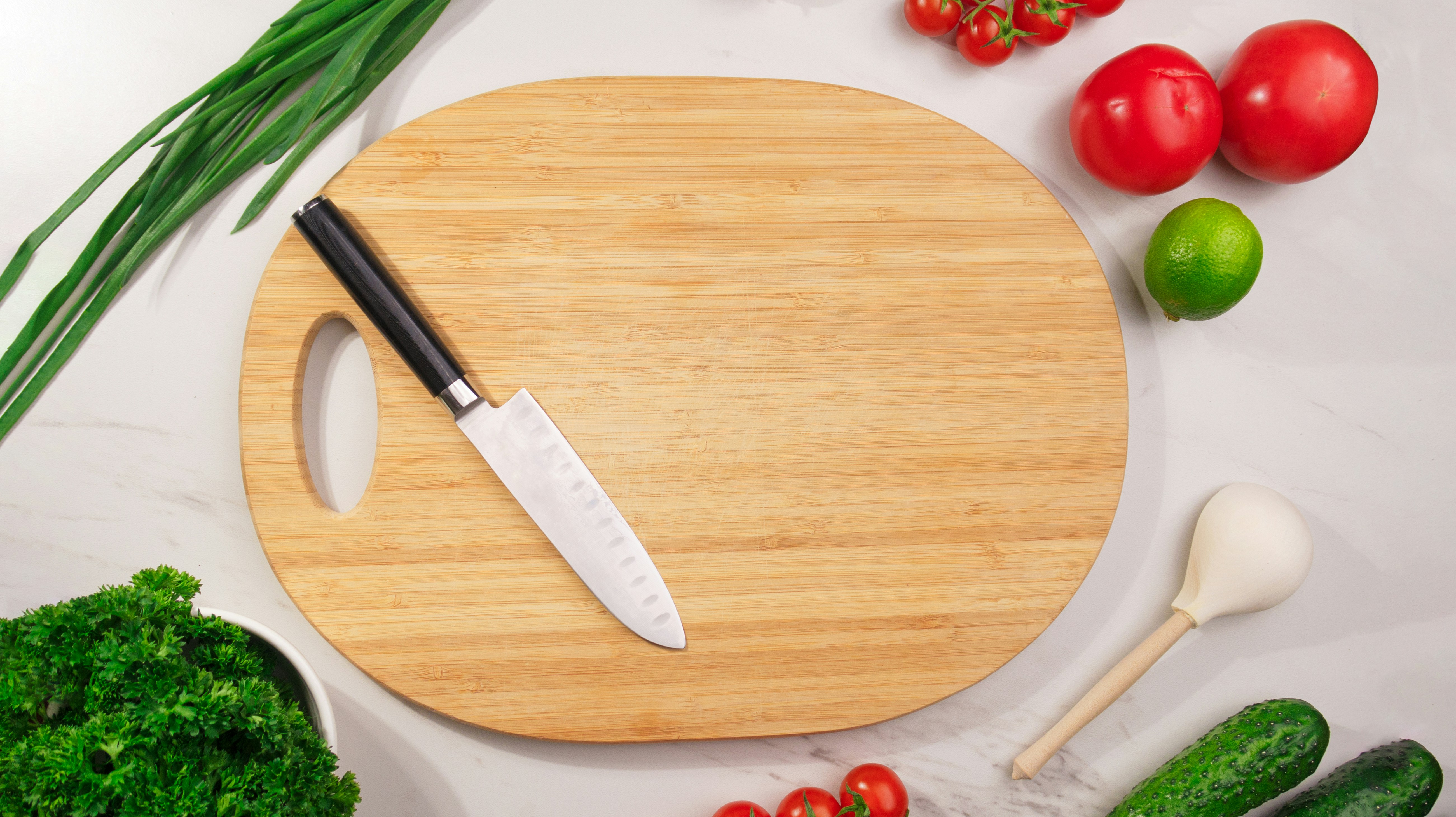 Sharp Kitchen Knives On A Wooden Cutting Board With Fresh Vegetables And Herbs