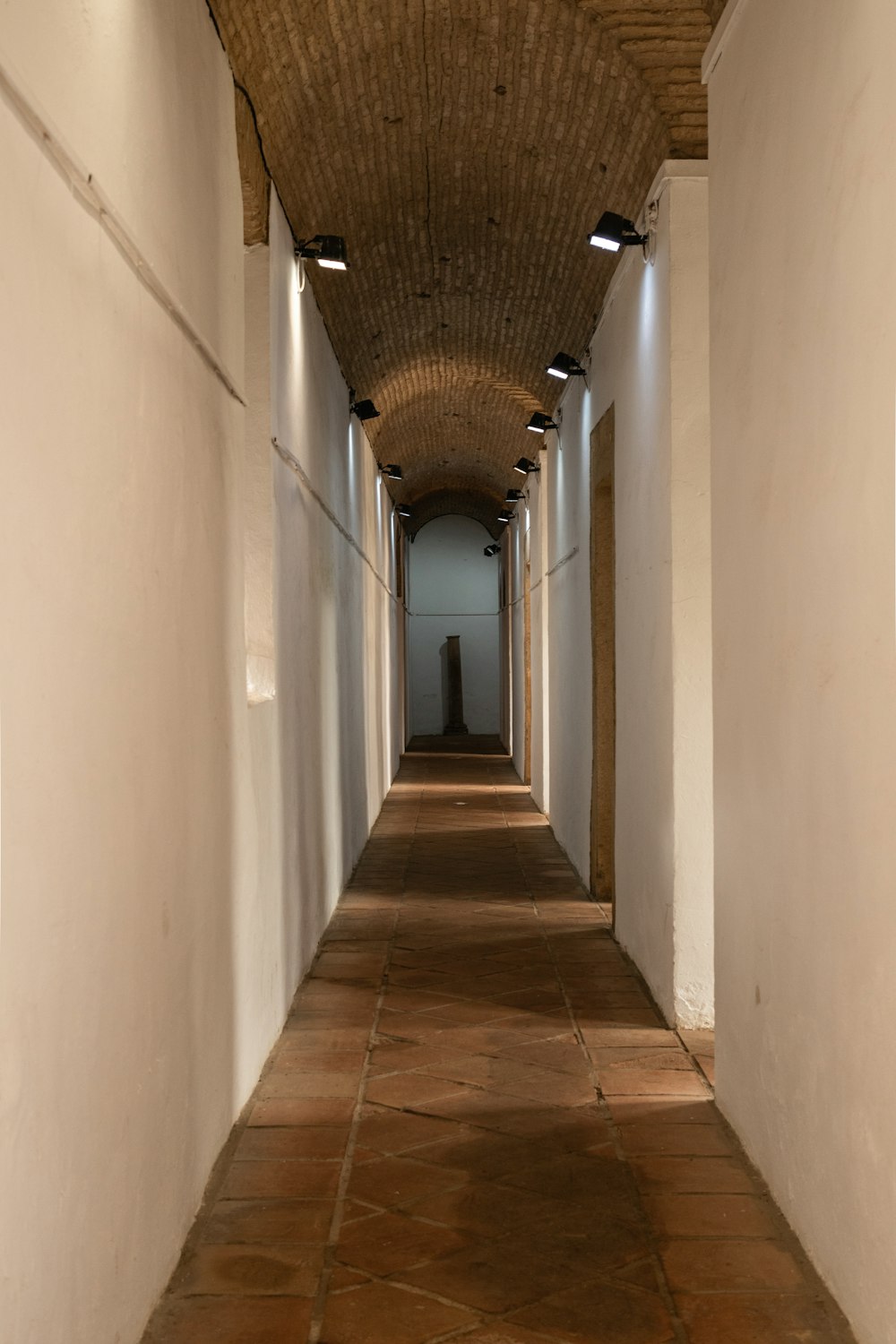 a hallway with a light on the end