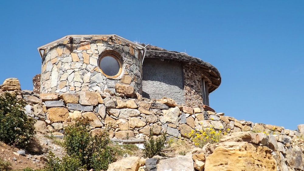 a stone building with a round window