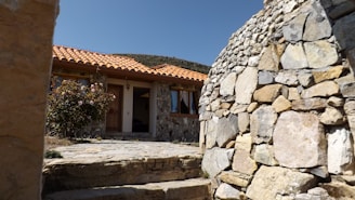 a stone building with a stone wall