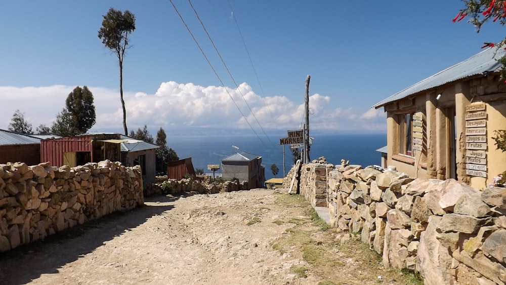 a stone path with buildings on either side of it