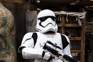 A battle-worn soldier in iron-grey armor, wielding a plasma rifle amid a dark asteroid field.