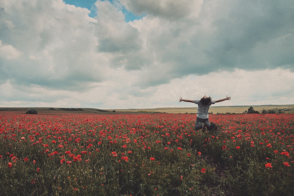 a person standing in a field of flowers