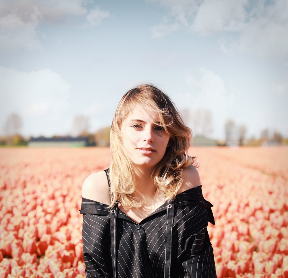 a woman standing in a field of flowers