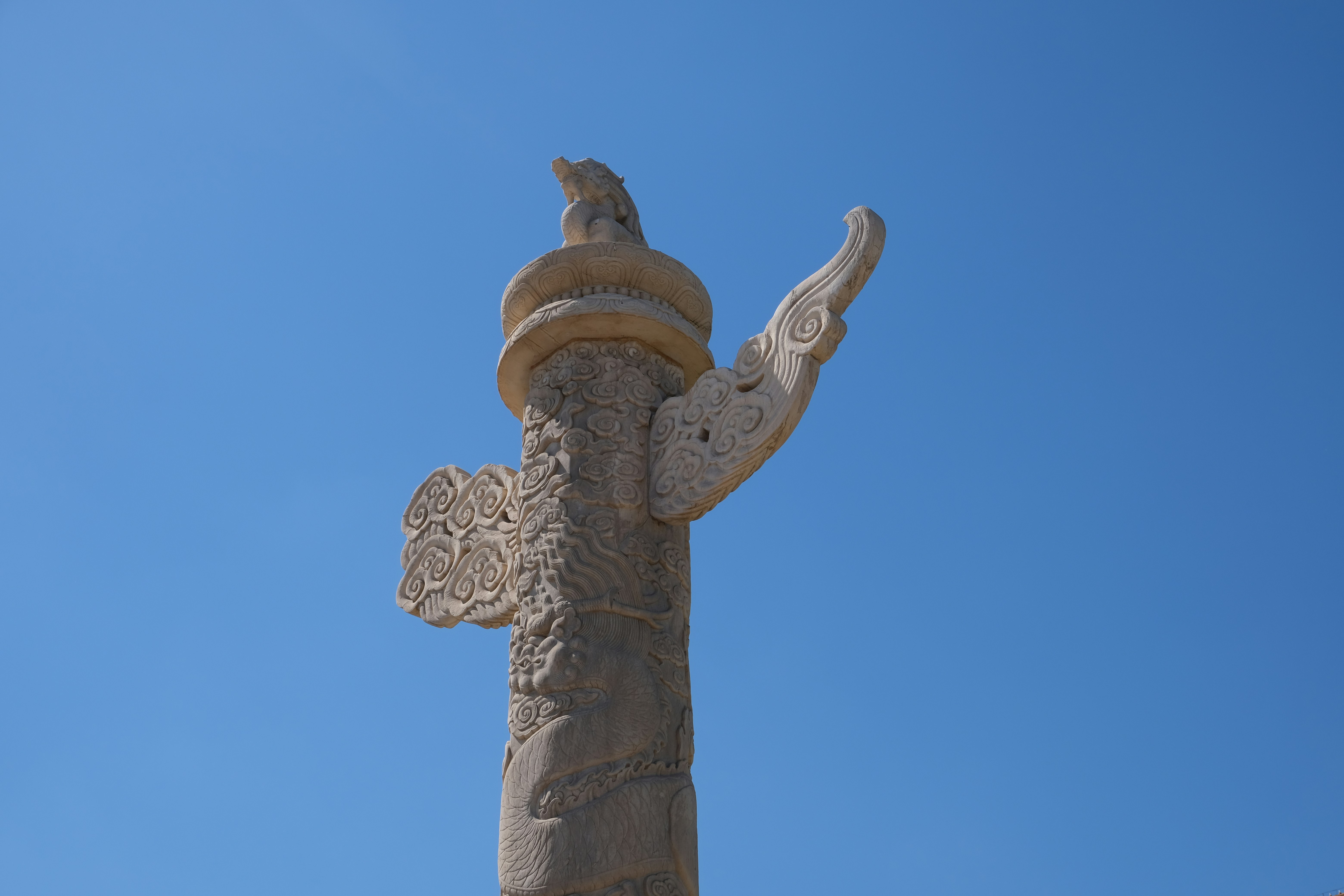 a statue of a person holding a cross