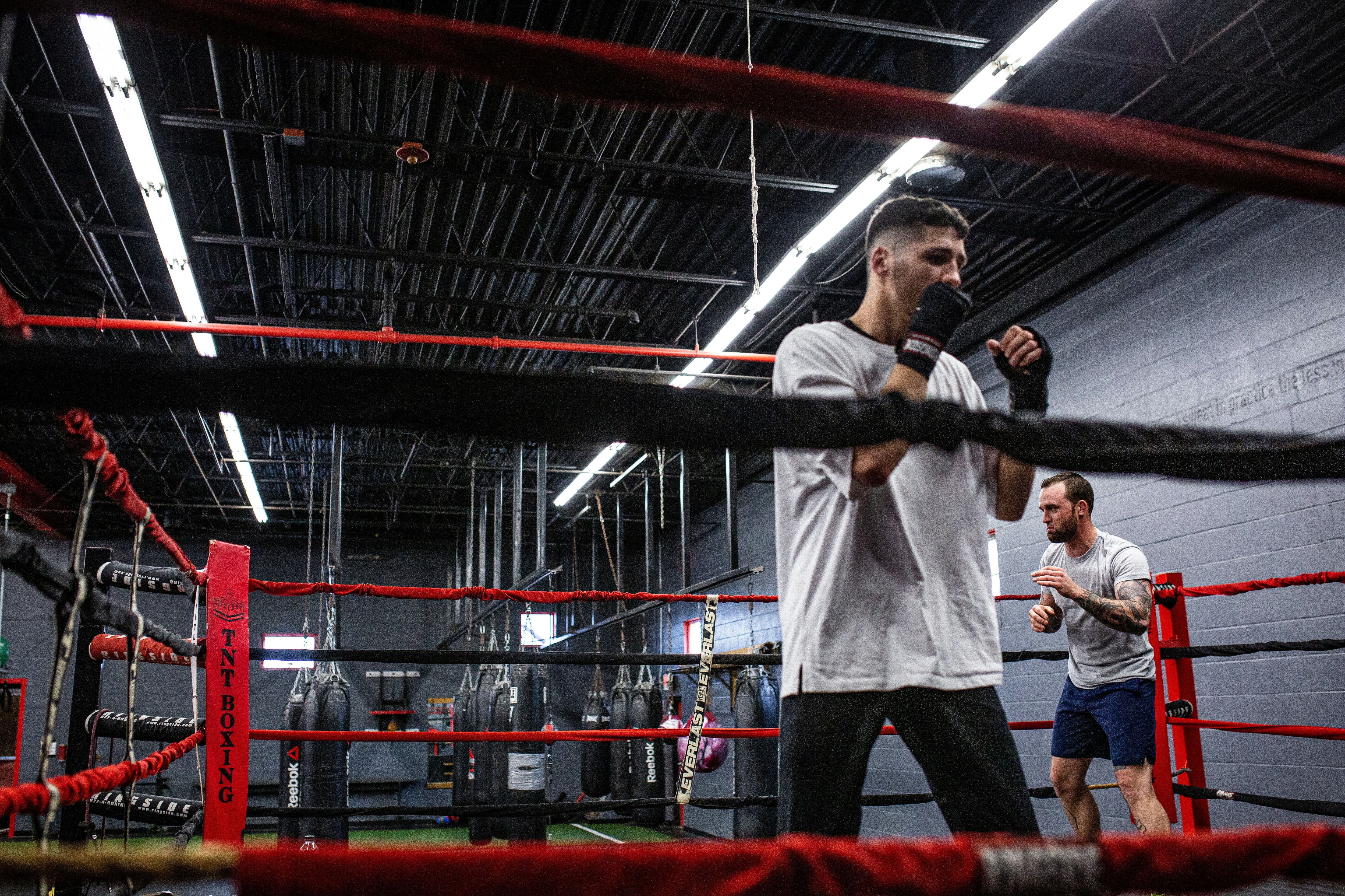 a man holding a microphone in a boxing ring