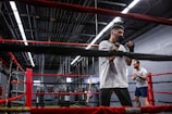 Veterans sparring in a well-lit boxing ring.