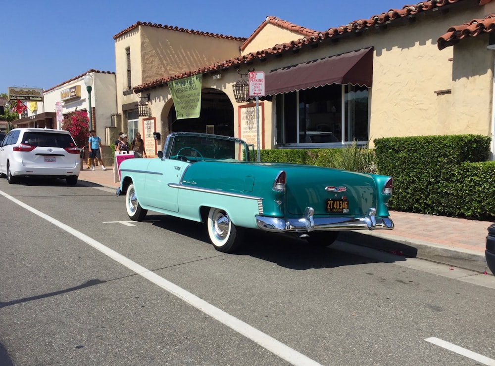 a blue car parked on the side of a street