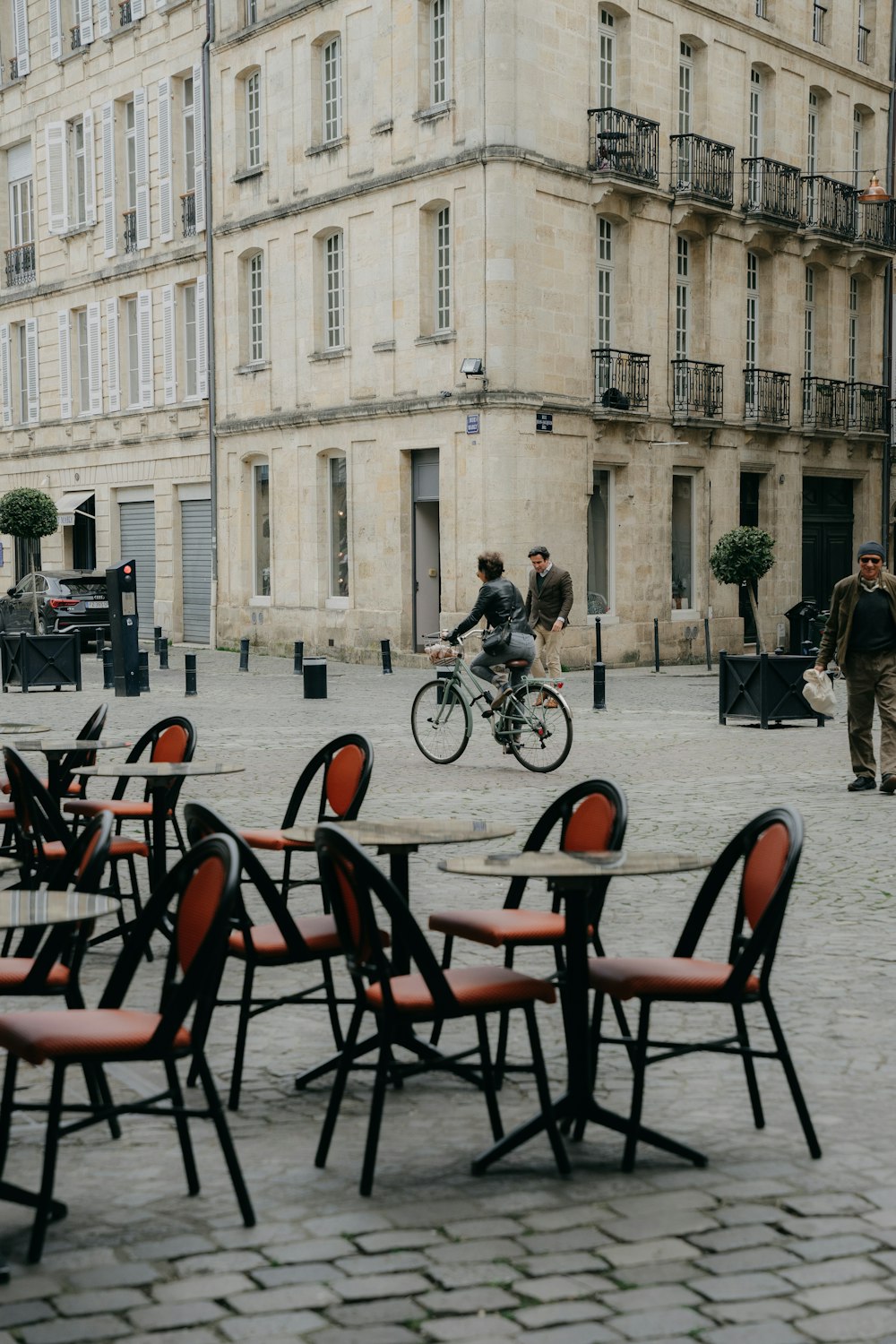 a person riding a bicycle on a street with a group of people