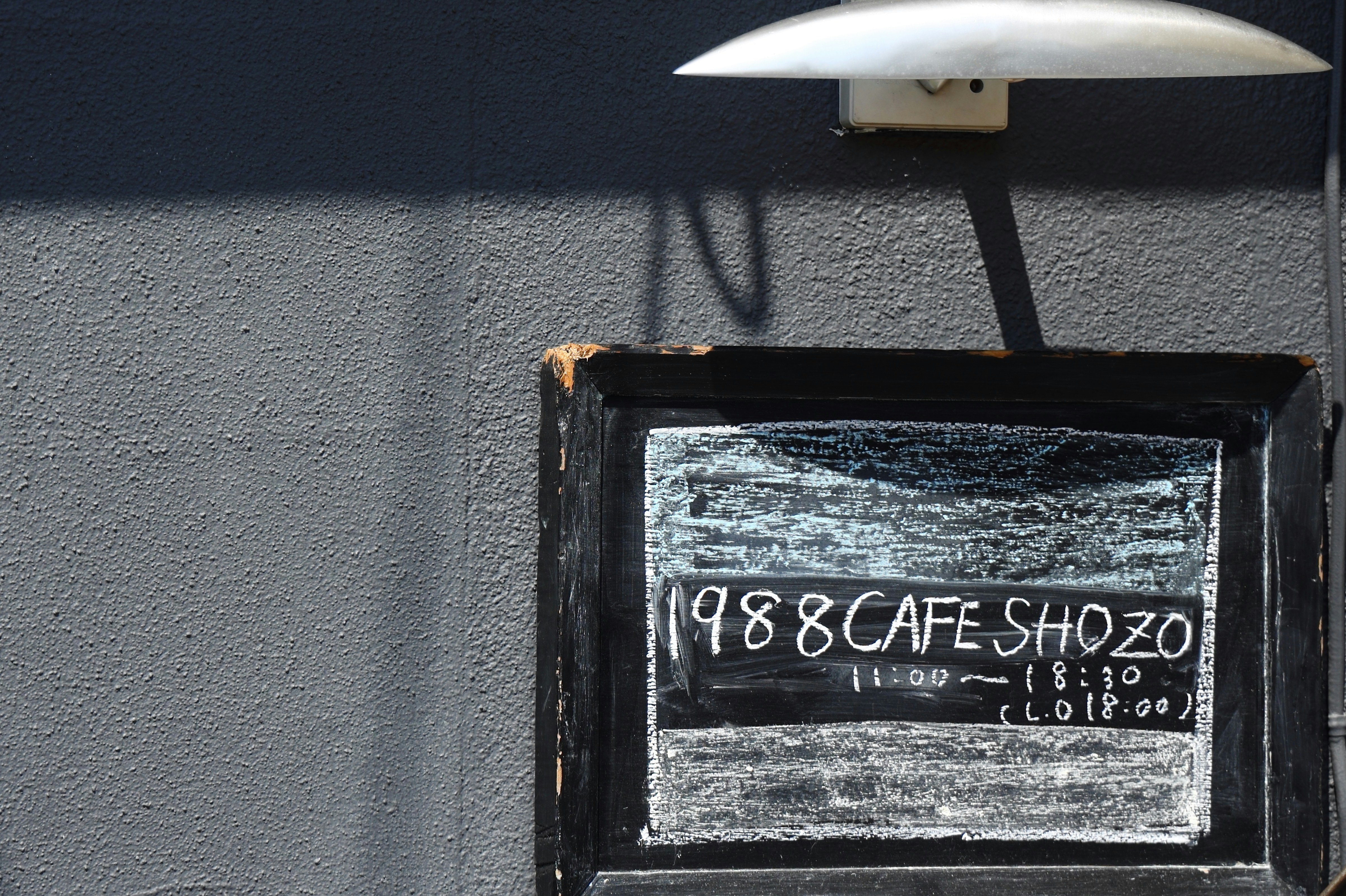 a black rectangular object with a white sign on it