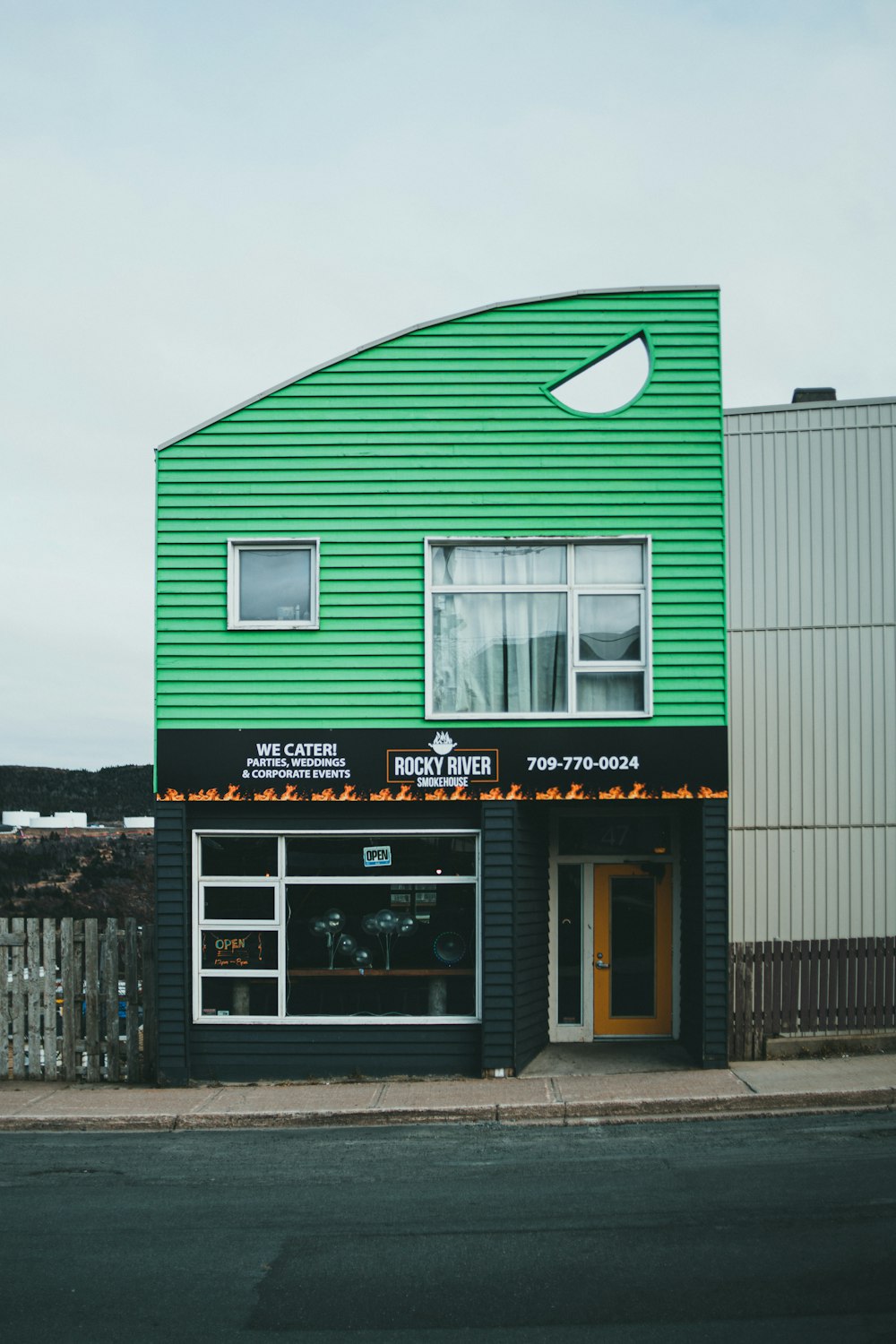 a green building with a sign on it