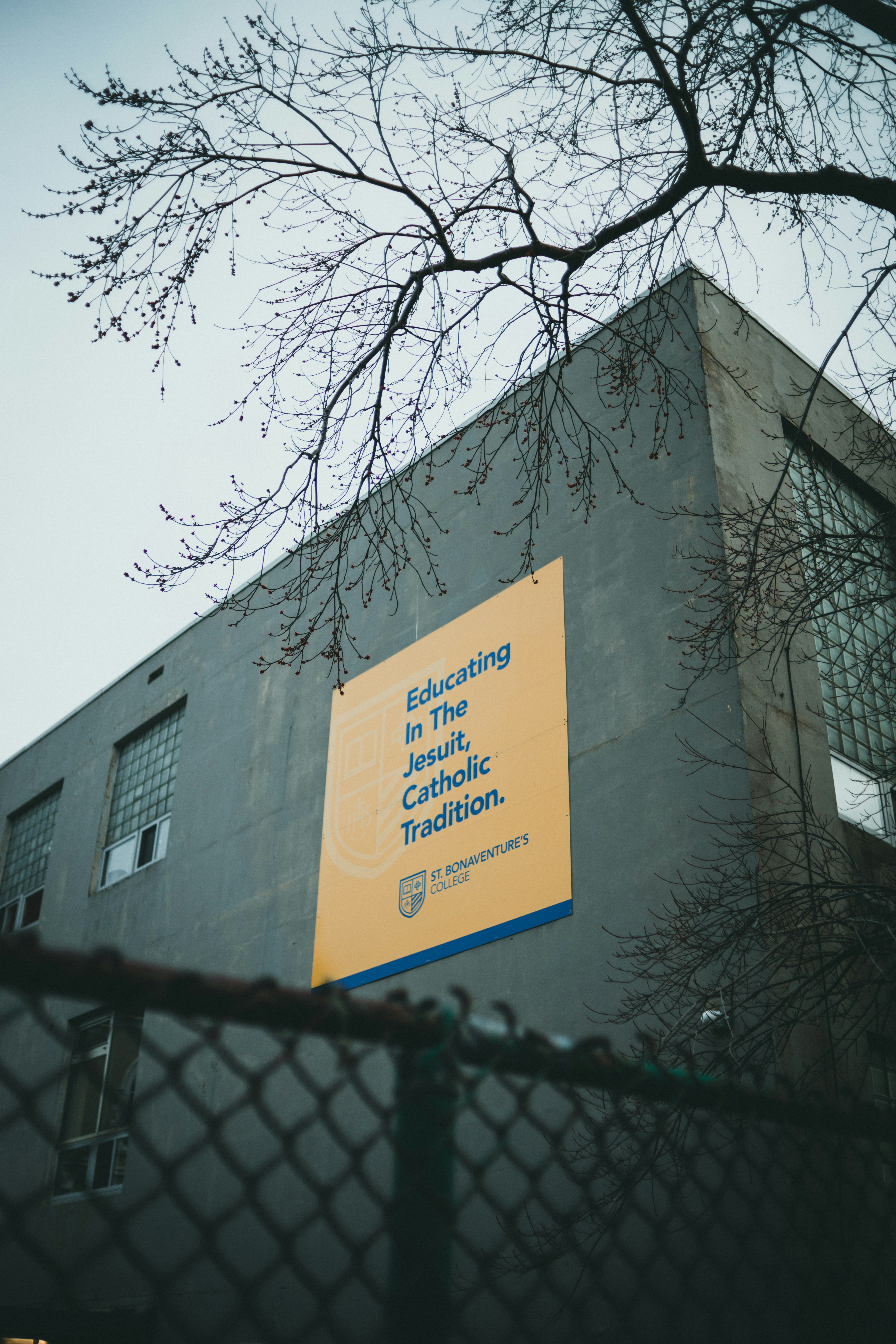 A yellow sign on a building photo – Free Brown Image on Unsplash