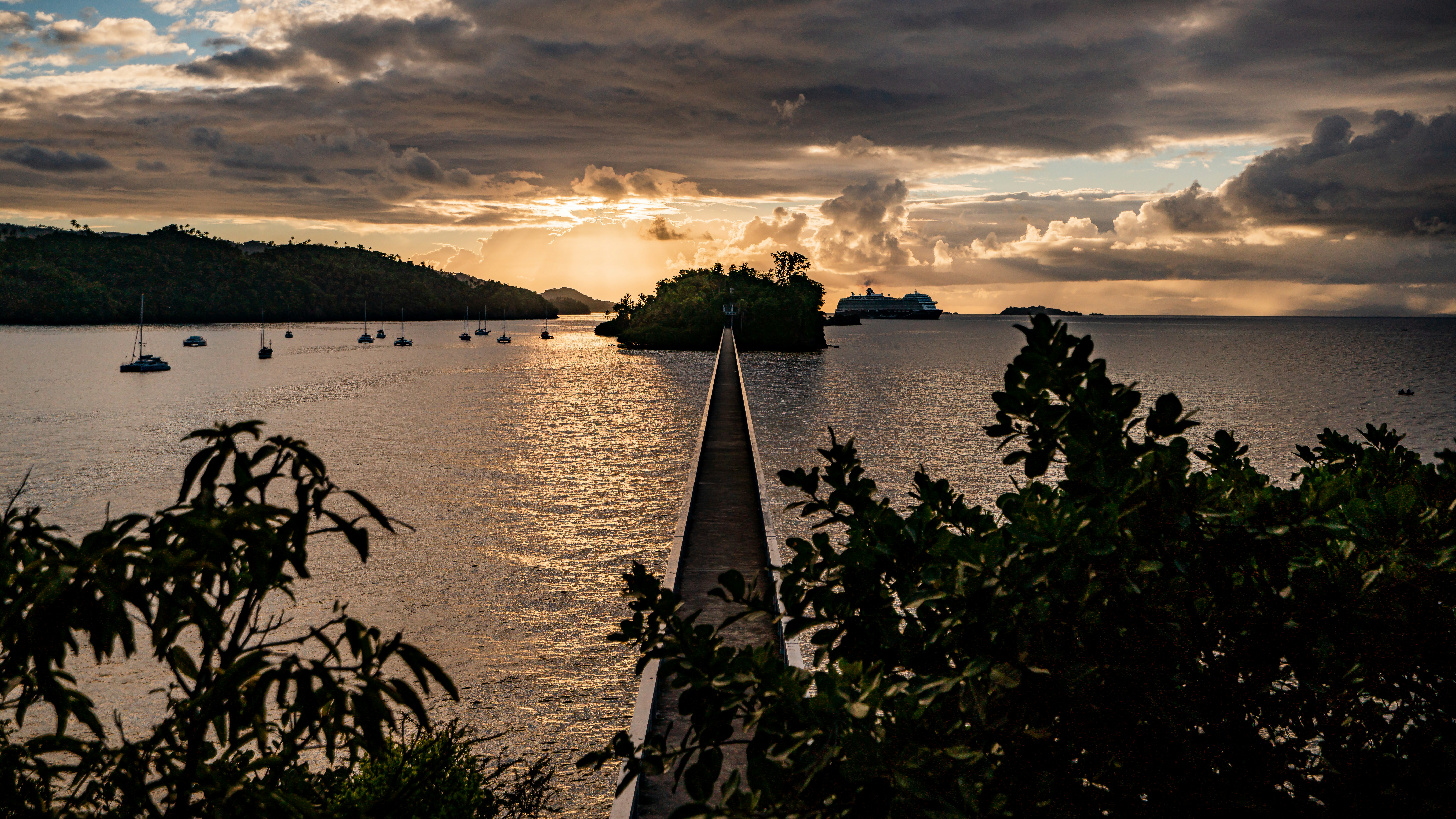 a body of water with boats and trees around it