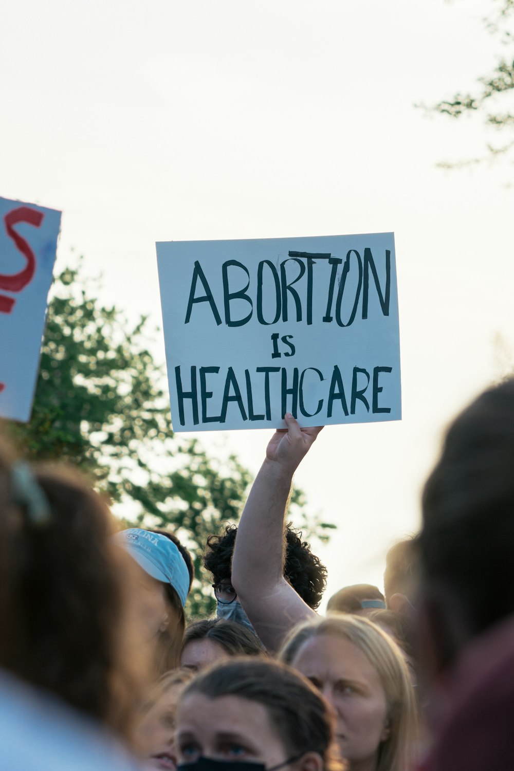 a group of people holding a sign