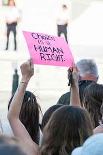 a female holding a sign my choice