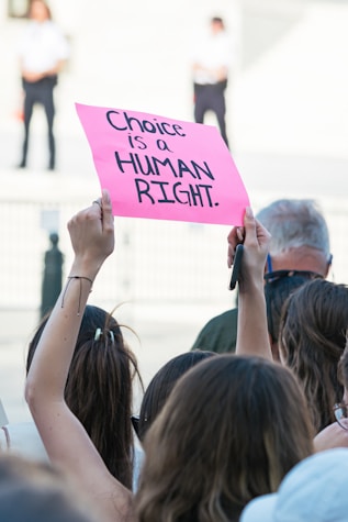 a female holding a sign my choice